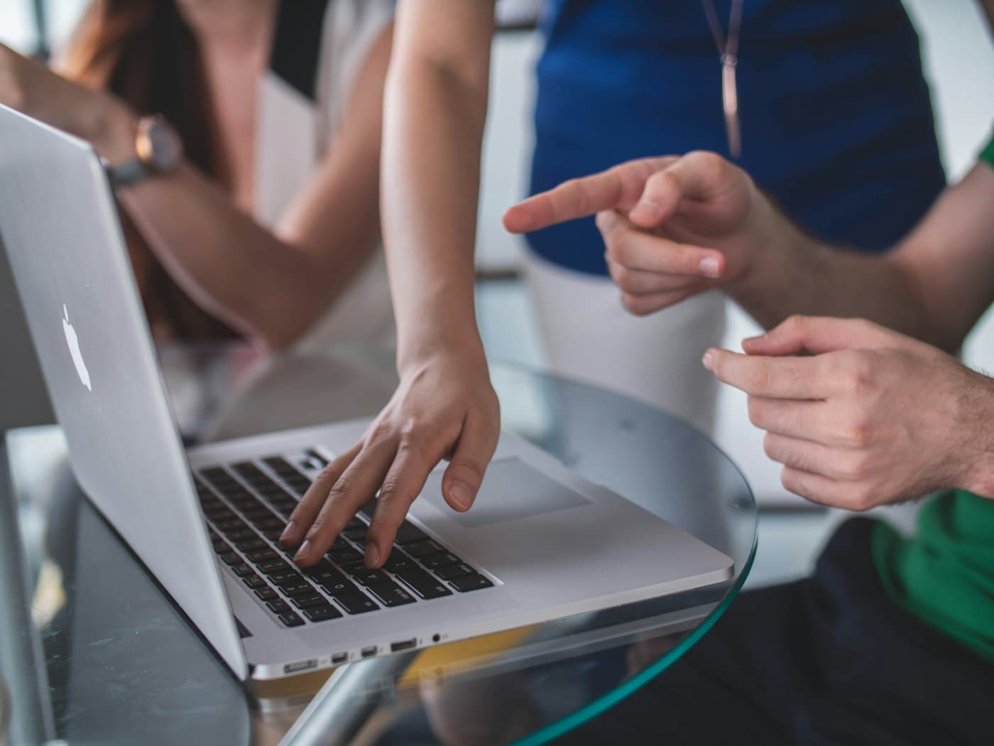 Two people reviewing work on a laptop